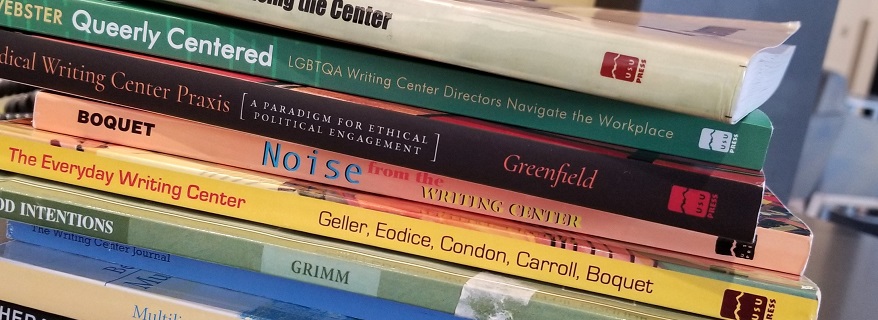 a stack of writing center theory books