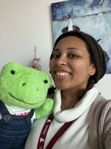 a photo of naomi and her stuffed animal frog