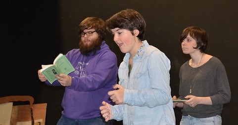 Students with scripts in drama class