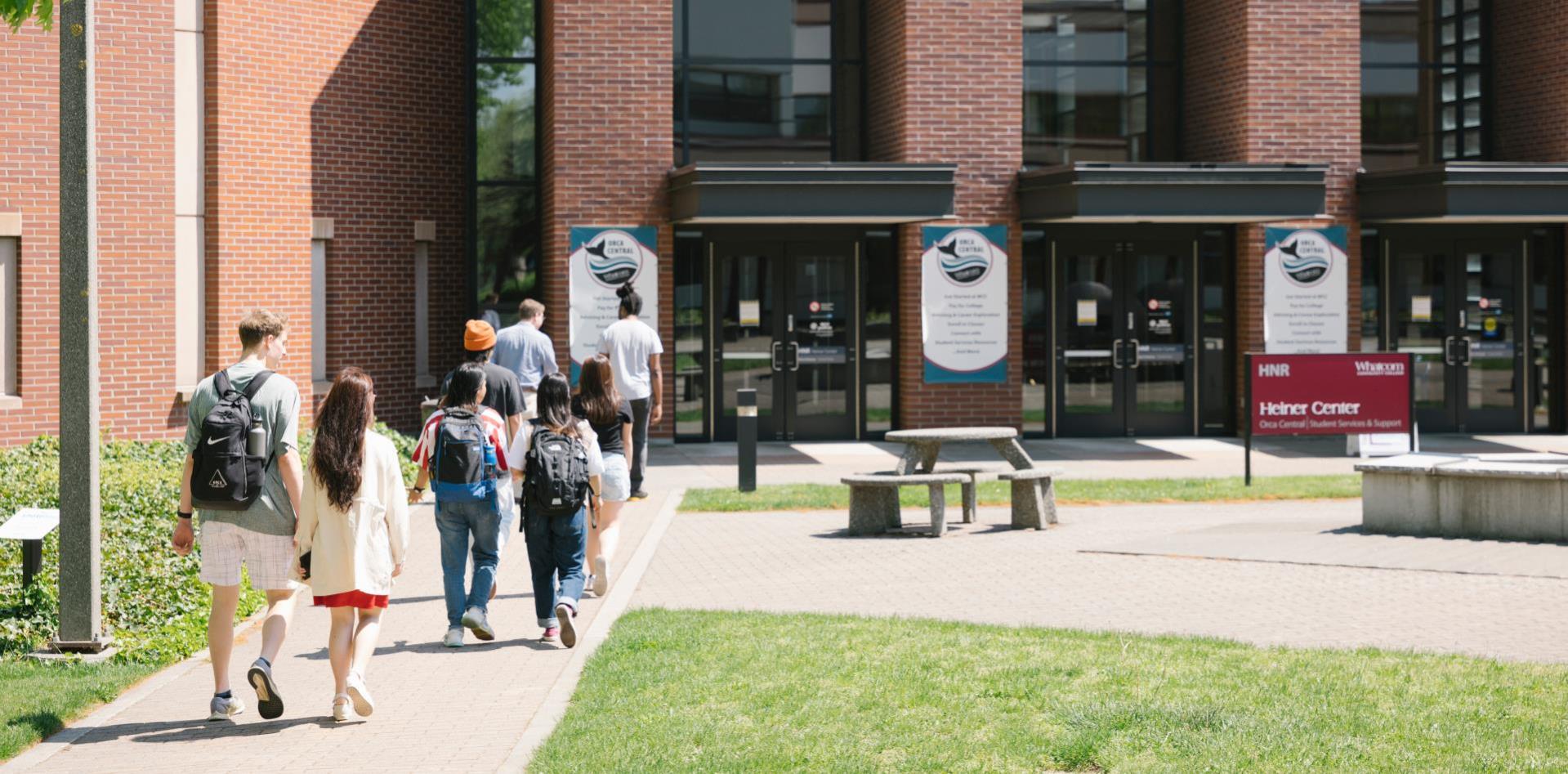 An image of a group of students walking into Heiner Center