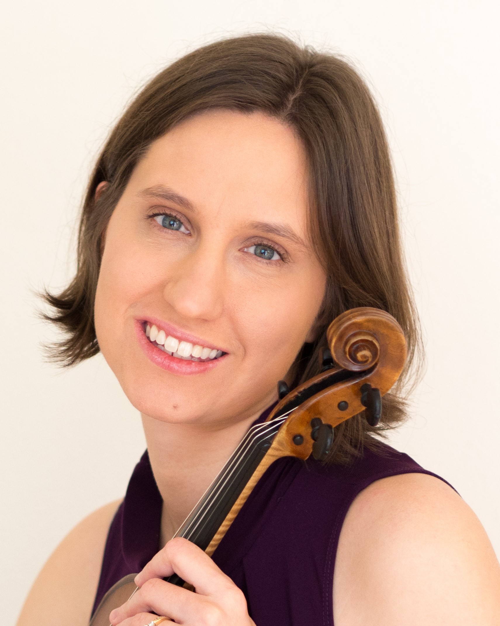 Faculty member Heather Ray against a white background holding a violin