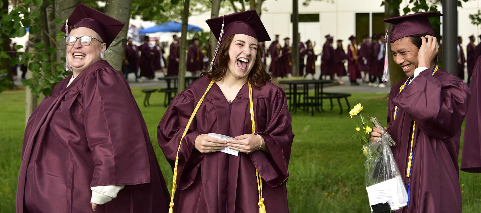 WCC graduates smiling while in line to walk the stage during commencement